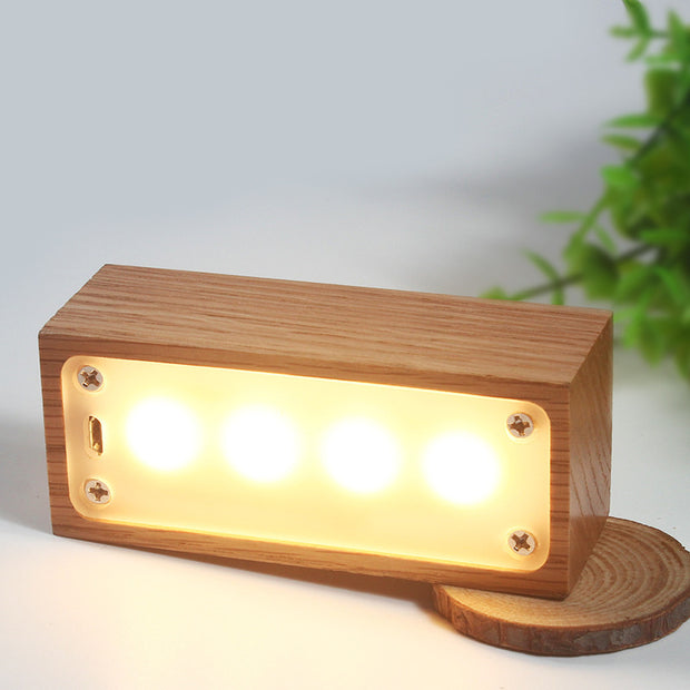 creative small night light gifts made of red oak log, glowing softly in a cozy setting.